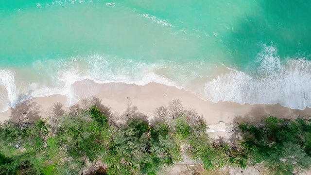 Aerial view drone shot of seascape scenic wave crashing on the sandy shore