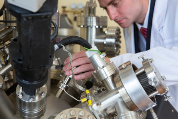 laboratory specialist examines the data obtained on a special apparatus for analyzing samples