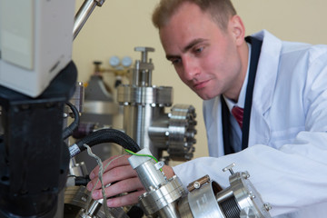 laboratory specialist examines the data obtained on a special apparatus for analyzing samples