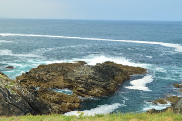 Views Of The Bay With The Waves Breaking On Its Rocks At Tapia De Casariego. Nature, Travel, Recreation. August 2, 2018.Tapia De Casareigo, Asturias, Spain.