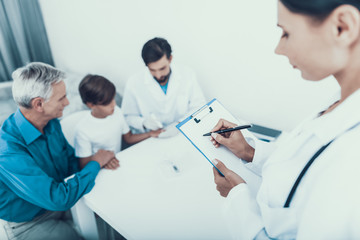 Doctor Taking Blood Sample from Boy's Finger.