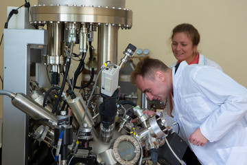 laboratory specialist examines the data obtained on a special apparatus for analyzing samples
