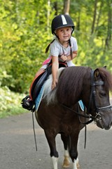 little girl riding a horse