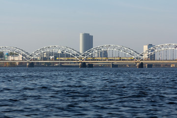 Naklejka premium Railway bridge in Riga over the Daugava River in the fall in October on a sunny day