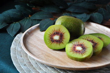 Beautiful Pieces of Red Kiwifruit on Wooden Plate