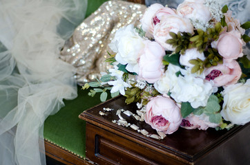 wedding accessories, bridesmaid shoes, vintage sofa and flowers on grey background