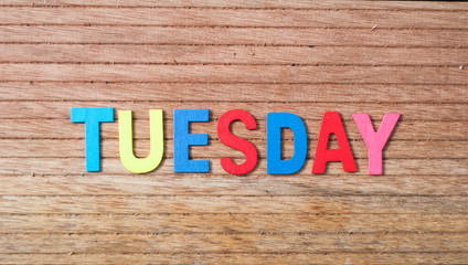 Colorful wooden alphabet with text tuesday