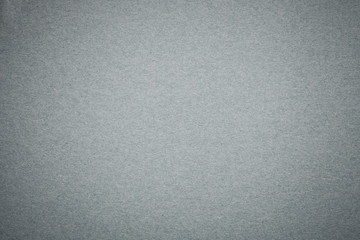 Texture of old gray paper background, closeup. Structure of dense light silver cardboard.