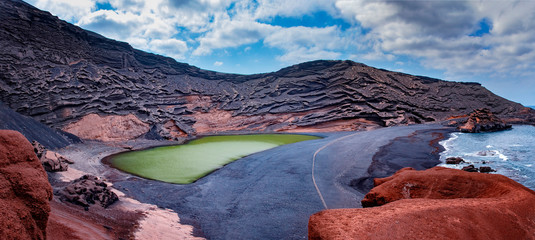 Green lake El Golfo on Lanzarote in Canary islands. There is black beach and blueocean. 