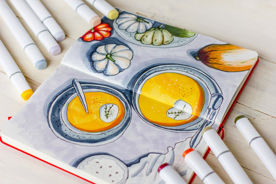 Sketch drawing by markers in sketchbook Pumpkin soup, flat lay