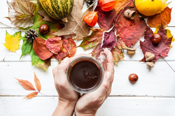 Cup of coffee and autumn leaves.