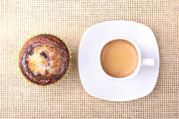 Homemade Chocolate chips muffins with coffee on wooden background
