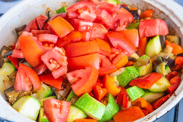 Vegetable stew cooked in a large frying pan, close-up, top view