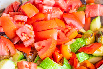 Vegetable stew cooked in a large frying pan, close-up, top view