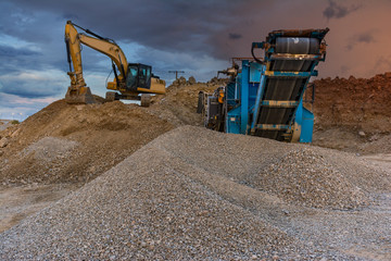 Excavator and machine to pulverize stone in a quarry