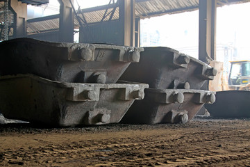 Huge metal car bucket in a warehouse workshop