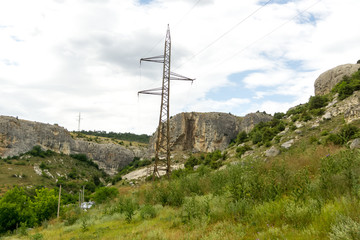 Obraz premium Power line pole in the mountains