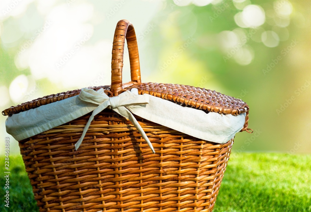 Poster Picnic Basket with napkin on nature background