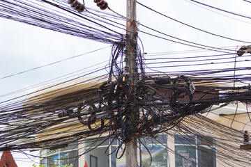 messy tangle electricity wire and communication cables in Thailand