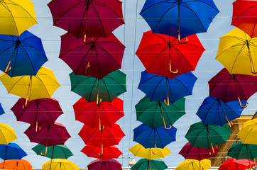 Fototapeta na wymiar colored umbrellas over your head