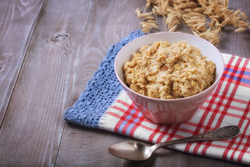 Oatmeal in a plate. Napkin. Nuts Berries. Honey
