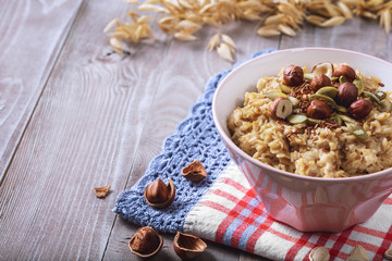 Oatmeal in a plate. Napkin. Nuts Berries. Honey