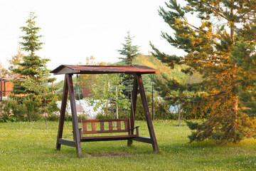 Beautiful wooden swing with a canopy