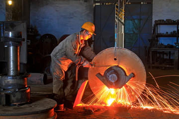 workers welding metal parts in a workshop, China
