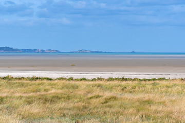 French landscape - Bretagne. A beautiful beach with grass in the foreground.