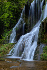 Fototapeta na wymiar French landscape - Jura. Waterfall in the Jura mountains after heavy rain.