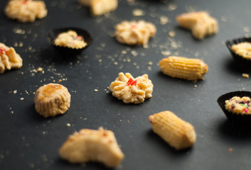 Cookies or biskut raya on black background. Special food for Eid festival or Hari raya