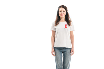 adult asian woman with aids awareness red ribbon on t-shirt looking at camera isolated on white