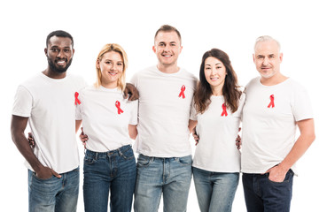 multiethnic group of people in blank white t-shirts with aids awareness red ribbons looking at...