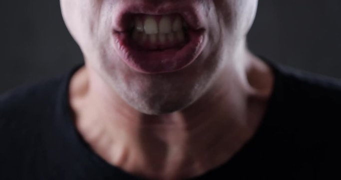Close-up of an Angry Man Screams and Insults and Threatens with Violence. 4K 10-bit
