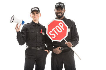 smiling police officers with stop road sign and megaphone looking at camera isolated on white, aids awareness concept