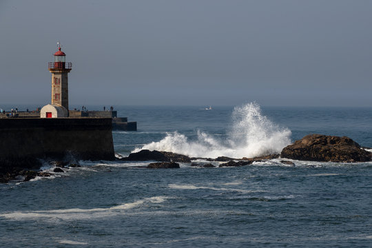 Waves crash the rocks near Felgueiras lighthouse in Porto city, Portugal