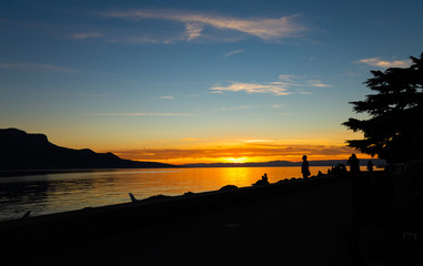 Sunset. Silhouette. People. Sky. Lake. Evening