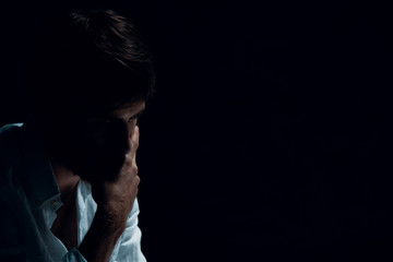 Portrait of handsome man with problems, copy space on the black background