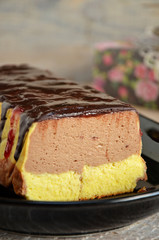 Two-tone fluffy cheesecake on a black dish