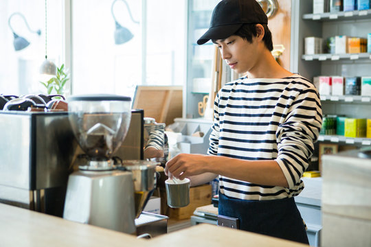 Barista making coffee in coffee shop
