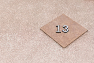 The plate with the number 13 on the wall.