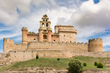 Naklejka premium The picture of the castle of Turégano, perched on the top of a hill that dominates the town and its monumental square, is one of the most suggestive and popular in Castile. (Segovia, Spain)