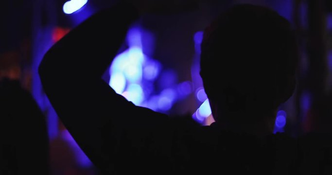 Silhouette of a man at a concert.