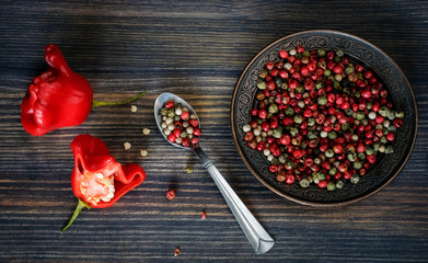 Fresh red peppers in the form of a roses, peas of pepper (red, white, green)