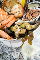 Plate with fresh assorted seafood in french summer restaurant