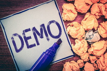 Writing note showing Demo. Business photo showcasing Demonstration of a product techniques and capabilities Public meeting.