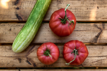 Organic Vegetables from a Small Garden on a Rustic Wooden Table - Tomatoes and Cucumber