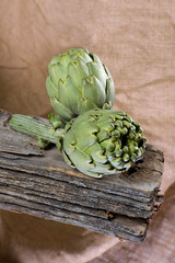 Artichokes on an old wooden board