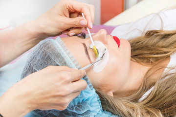 Woman on the procedure for eyelash extensions, eyelashes lamination 