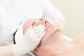 Man in the mask cosmetic procedure in spa salon. 